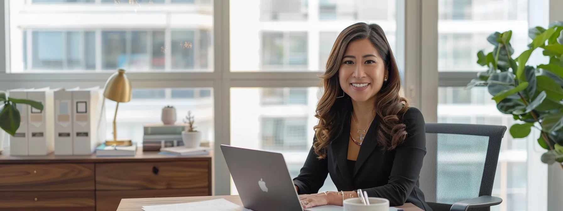 a sleek, modern office workspace features a polished wooden desk with an open, well-organized laptop displaying a professional email draft, alongside a neatly stacked assortment of product samples, all bathed in soft, natural light filtering through a large window.